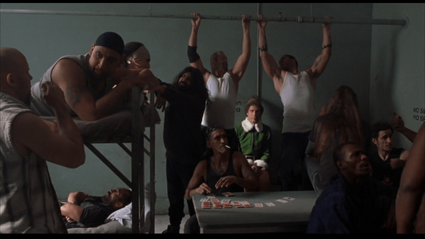 A extra in Elf similarly flaunts a "No Smoking" sign in jail