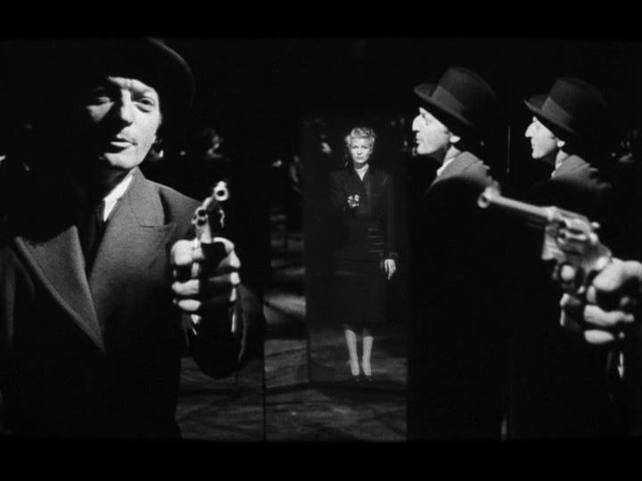 Tripartite split screen shot showing multiple mirrored images of Arthur and Else pointing guns at each other