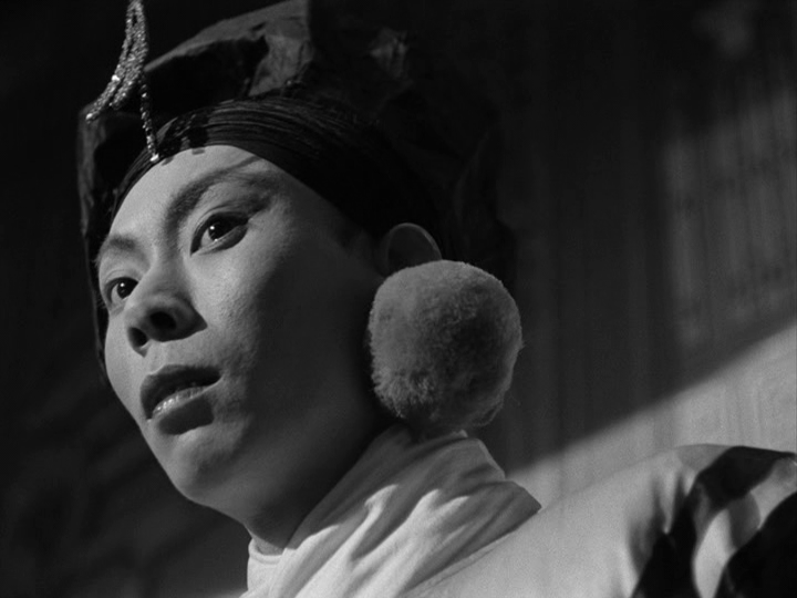 An actor on stage looks at the police officers who have entered the theater