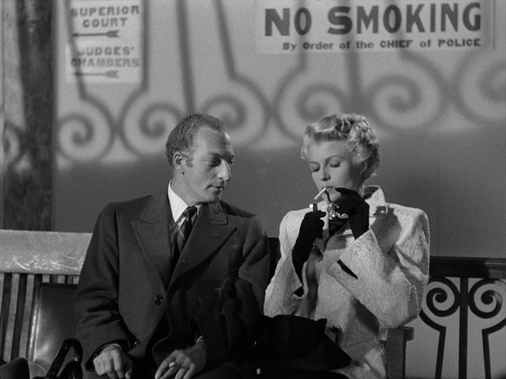 Arthur and Else enjoy cigarettes right in front of a sign that says "No Smoking"