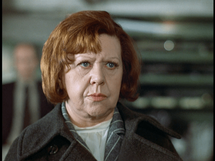 Another medium shot of Emmi staring at Ali