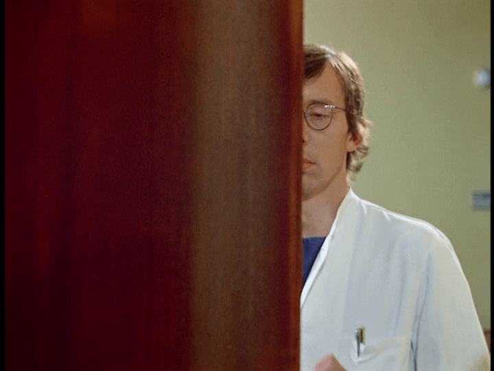 Medium shot of the doctor closing the door