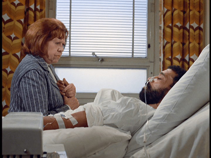 Medium shot of Emmi holding Ali's hand