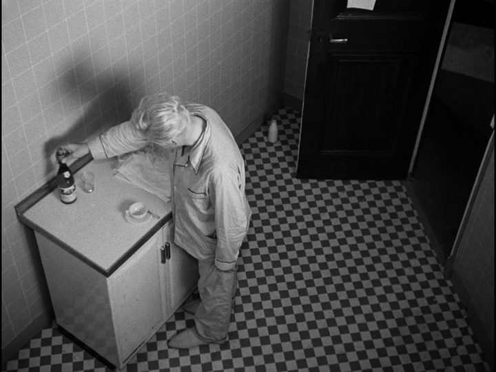 Overhead shot of Bob reading the label on a bottle of wine