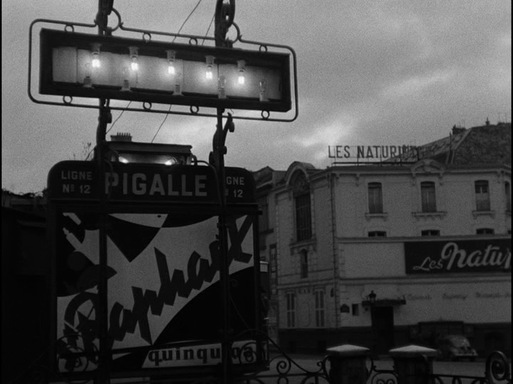 Long shot of neon signs at dawn