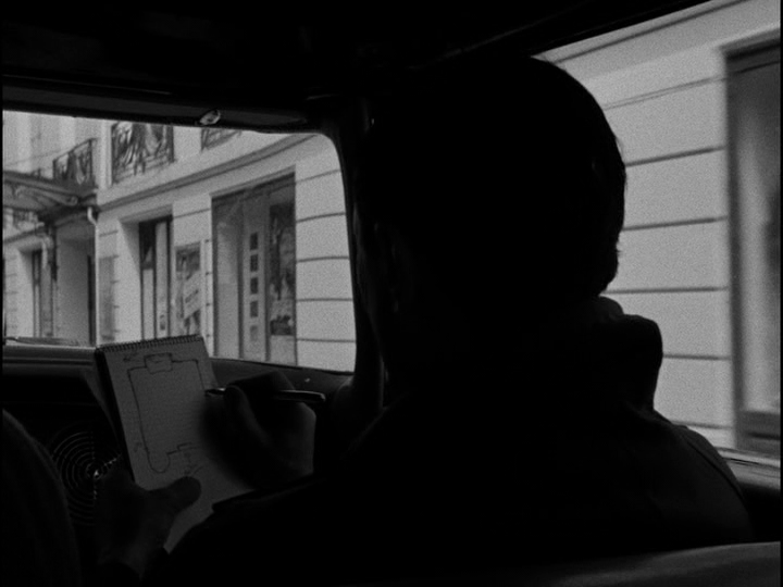 The car's passenger sketches the outline of the building