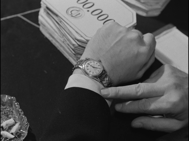 Close-up of Bob's watch showing the time as 5:00