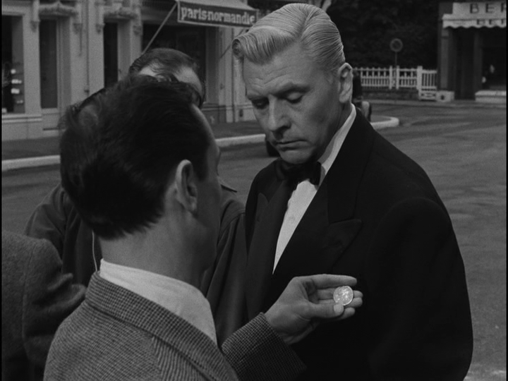 A police officer inspects the coin he just removed from Bob's pocket