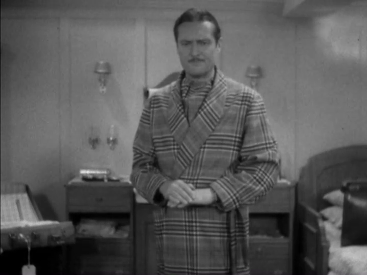 Medium-long shot of Dugan looking somewhat displeased at the result of the coin flip