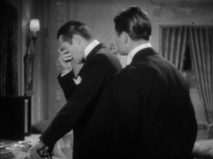 Medium shot of Curtis asking Dugan, who has his head in his hand, what is the matter