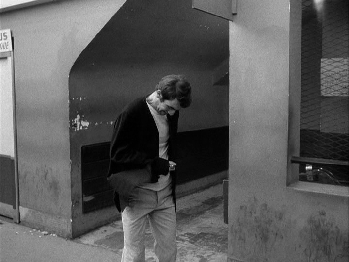 Medium shot of the same man stabbing himself in the stomach