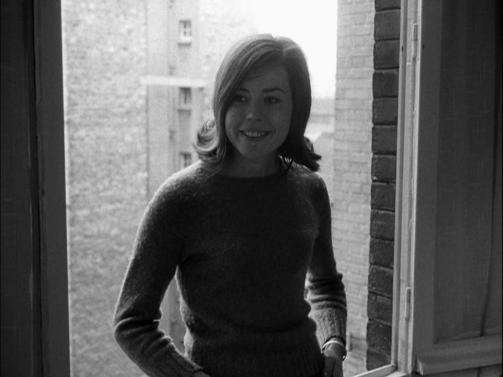 Medium shot of Miss 19 framed by a window