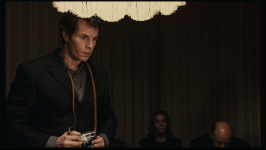 Medium shot of Isaac in the left third of the frame looking shocked