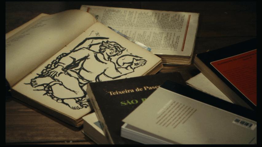 An illustration of an angel in a book lying open on a pile of others, which are closed