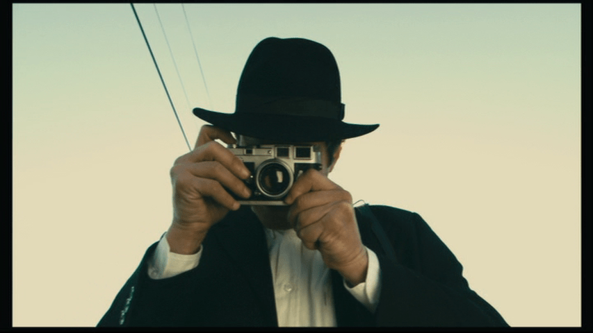 Close-up of Isaac facing the camera and taking a picture