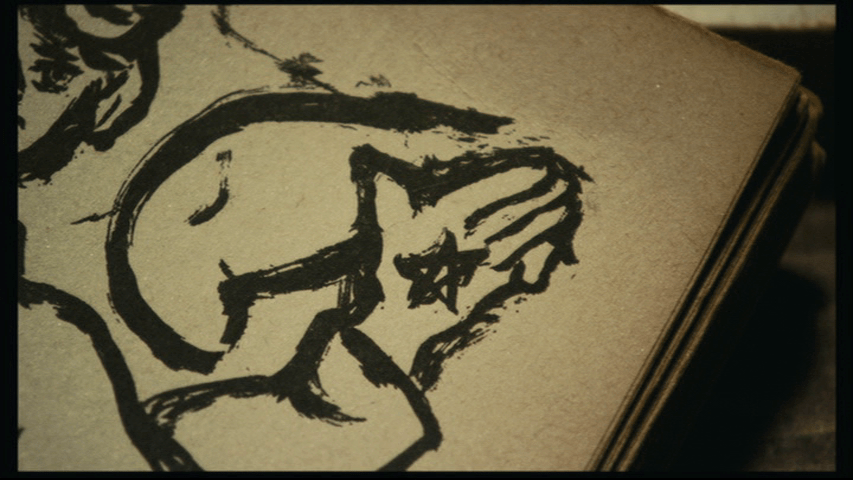 Close-up of a detail of a star in the palm of the angel's hand