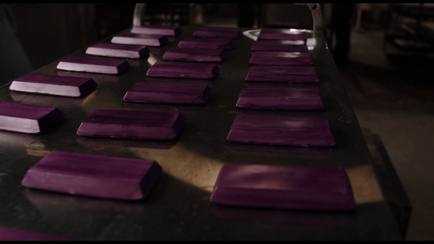 Close-up of purple "candy bars" on an assembly line