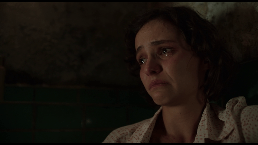 Close-up of Djuna's tear-stained face, which occupies the entire right side of the screen