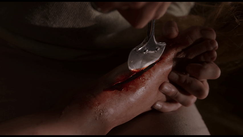 Close up of a blade cutting into a foot