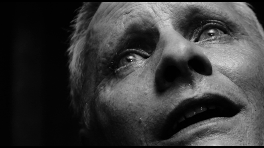 Black and white close-up of Saul's face in ecstasy occupying the entire right two-thirds of the frame as a tear rolls down his cheek