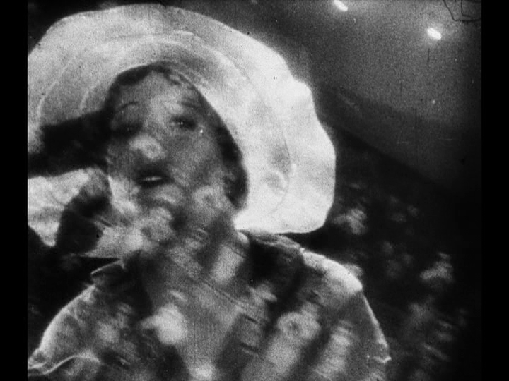 Close-up of Mary searching for Jim superimposed over a crowd shot