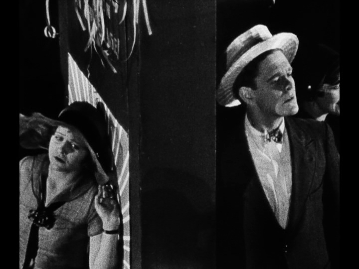 Medium long shot of Jim and Mary in the same frame, but not seeing each other because they are separated by a barrier