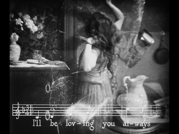 Long shot of Mary pounding on the walls of her apartment with both a record player and the music and lyrics from the song "Always" superimposed over it
