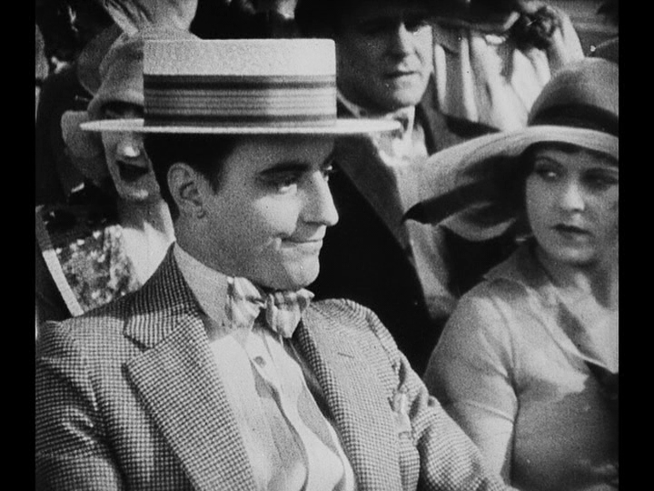 Medium shot of a young man looking perturbed on the left side of the frame as Mary glares at him from the right