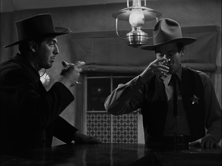 Medium shot of Henry Fonda's Wyatt Earp taking a sip of champagne with Victor Mature's Doc Holliday