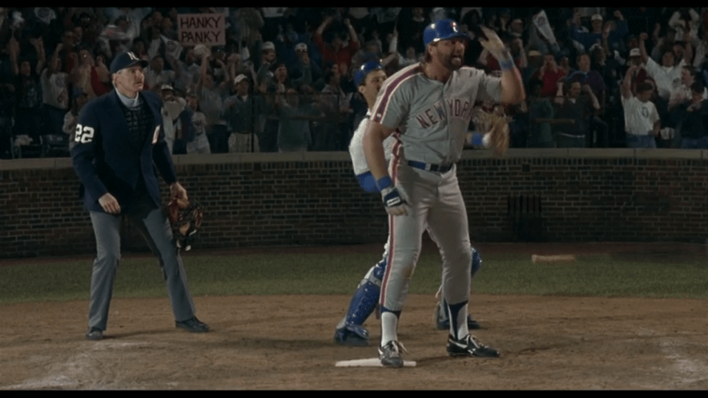 Heddo tosses his bat in frustration, again in long shot in front of the Cubs catcher and the umpire