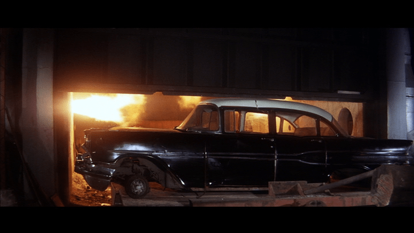 Medium shot of a car in front of an incinerator
