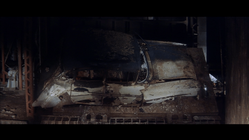 The car, which is now burnt, being dumped out onto the ground