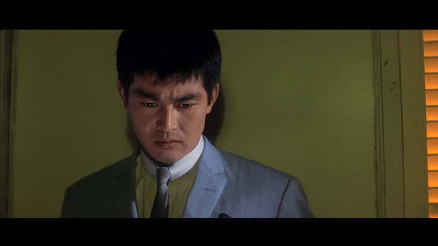 Medium shot of Tetsu in front of a lime green background