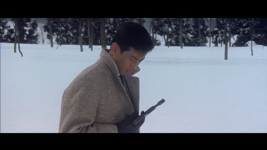 Medium shot of Tatsu checking his gun