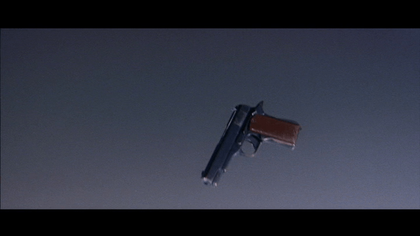 Close-up of a gun suspended in mid-air