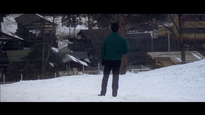 Exterior long shot of Shooting Star standing in the snow in the center of the frame with his back to the camera