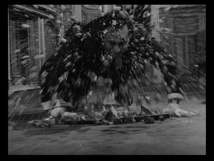 Close up of a waiter falling face-first toward the camera as food explodes outward from the tray he was cerrying