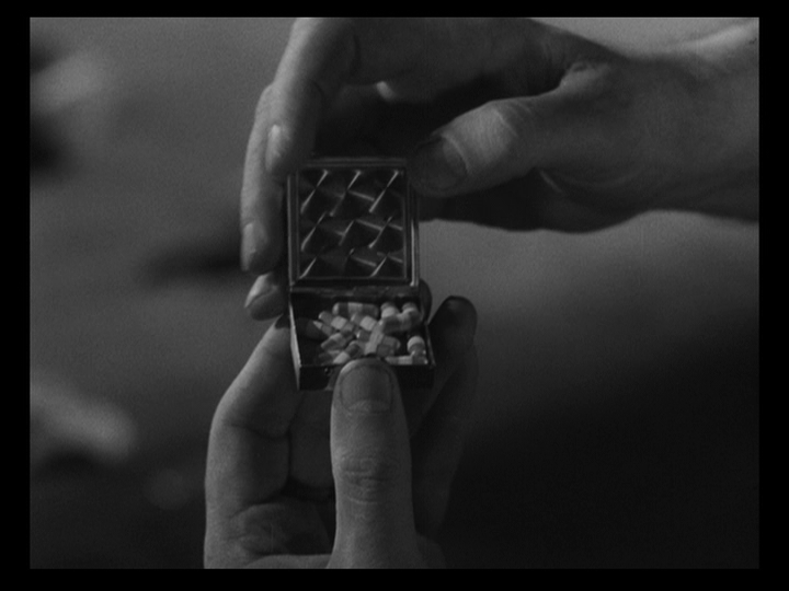 Close-up of hands opening a pill box