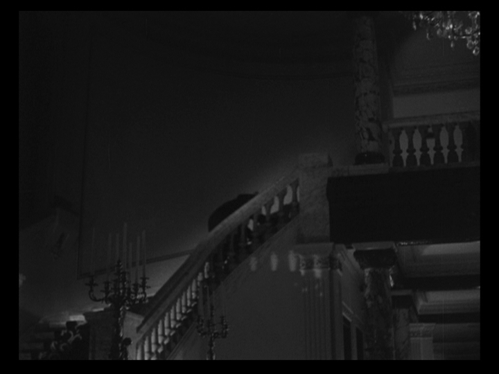 Long shot of a bear climbing the stairs of the mansion