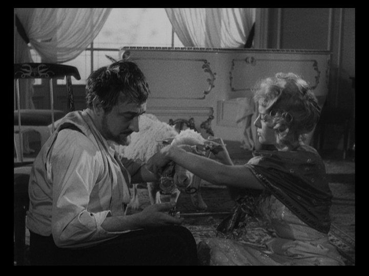 The Valkyrie blindfolds one of the sheep as Edmundo prepares to slaughter with a knife