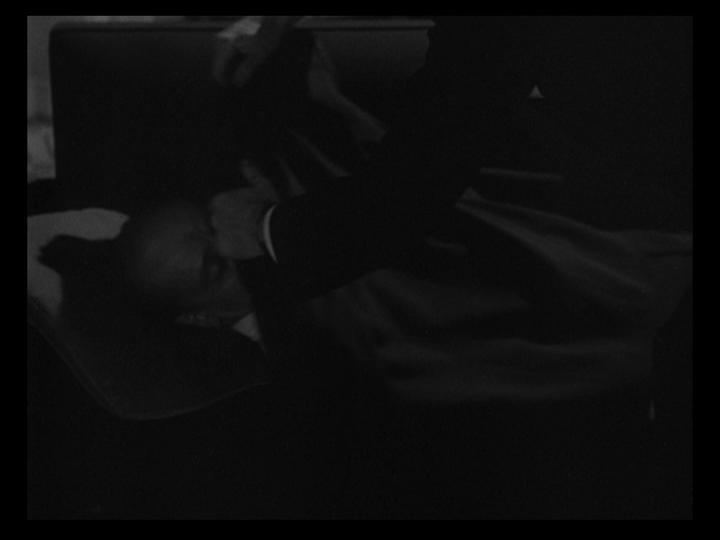 Hands cover Mr. Russell's body with a sheet