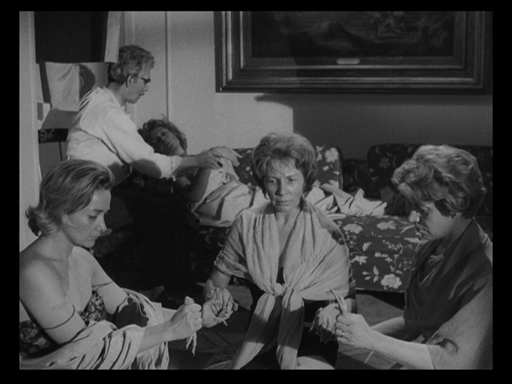 Medium shot of Ana (Nadia Haro Oliva) leading two companions in a kabbalistic ritual