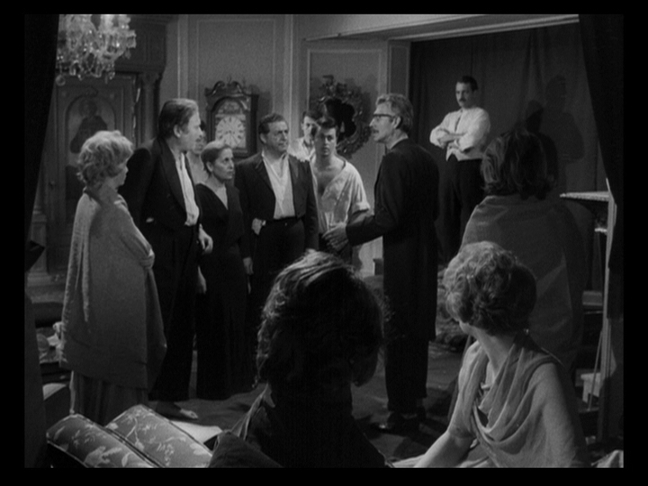 Long shot of Dr. Conde confronting a group of guests who want to kill Edmundo