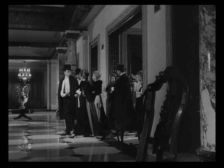 Long shot of the Nobiles and their guests entering the mansion