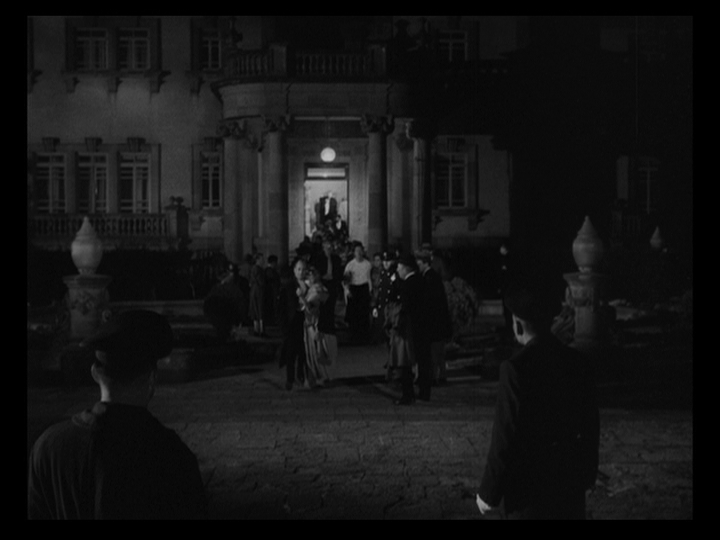 Long shot of the guests emerging from the Nobile's mansion