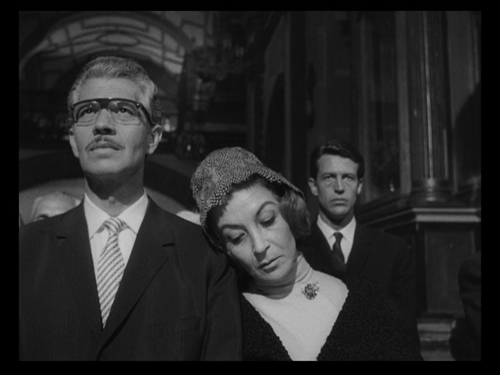 Medium shot panning over the Nobile's guests, including Dr. Conde and Julio