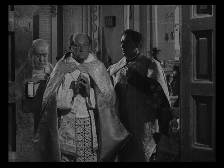 Medium shot of the three priests stopped at the door to the cathedral