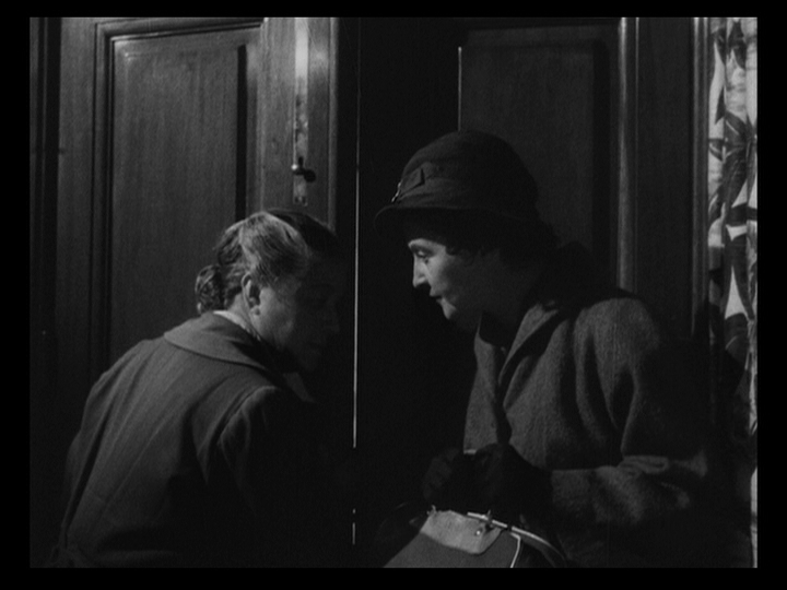 Medium shot of the maids listening at a door for the Nobiles and their guests to finish going upstairs