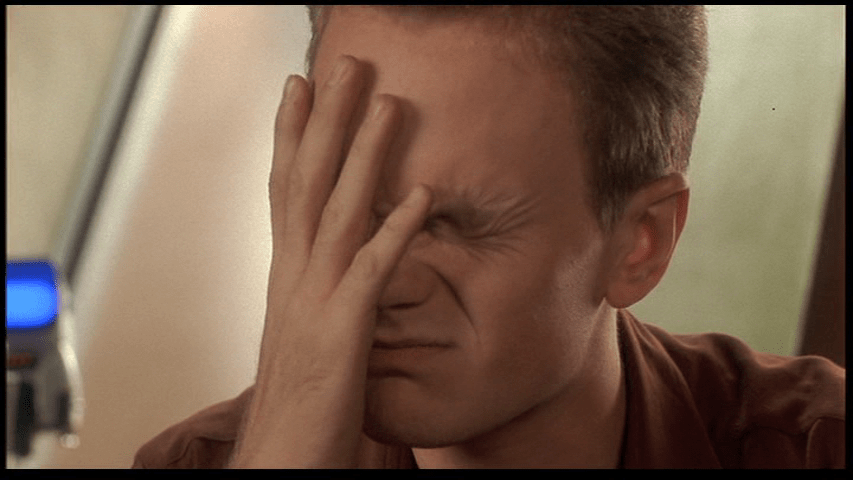 Close-up of an exasperated Carl with his head in his hands after Johnny clearly fails to correctly identified the face down card