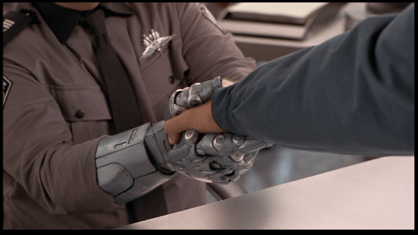 Close-up of the recruiting sergeant gripping Johnny's arm with both hands